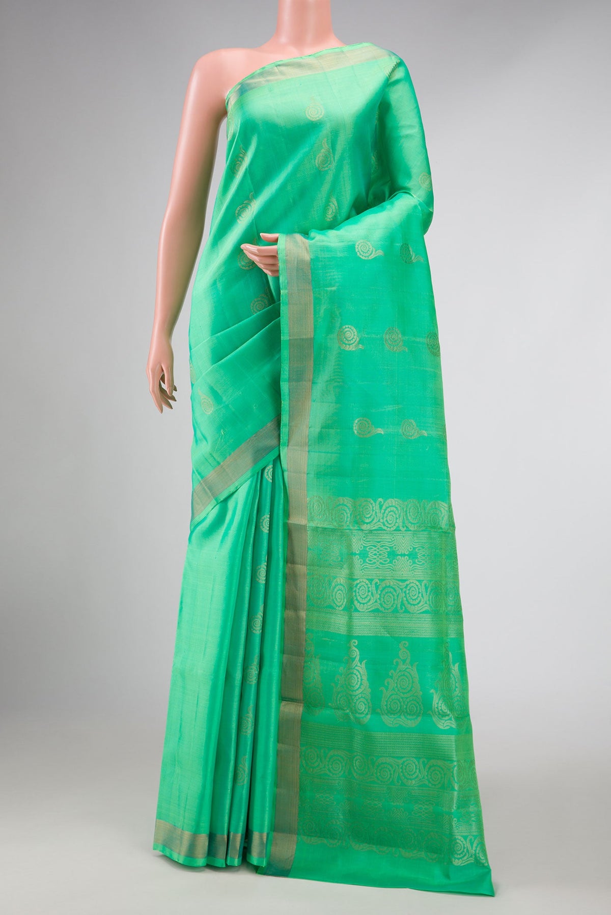 Light Green Dual Tone Soft Silk Saree with Zari Butta on the body and Zari Border displayed on a mannequin