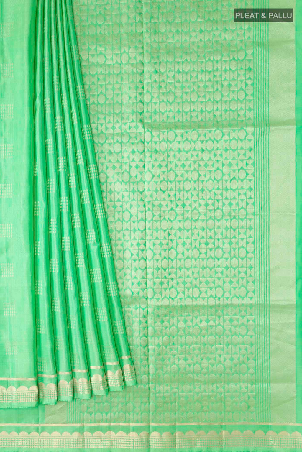 Pleats and pallu of Green Soft Silk Saree with Zari Butta on the body and Zari Border