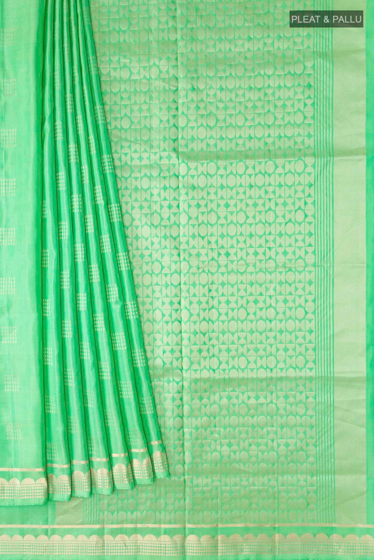 Pleats and pallu of Green Soft Silk Saree with Zari Butta on the body and Zari Border