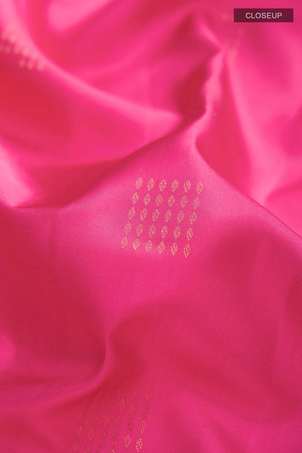 Close up of Pink Soft Silk Saree with Zari Butta on the body and Zari Border displaying folds