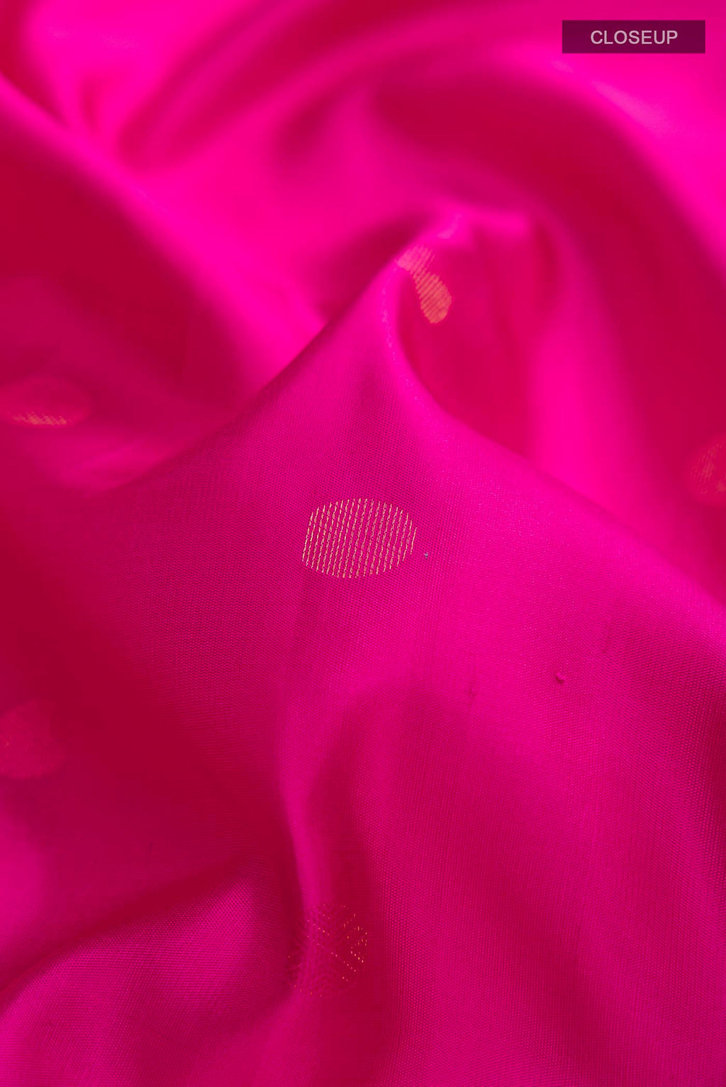 Close up of Pink Soft Silk Saree with Zari Butta on the body and Zari Border displaying folds