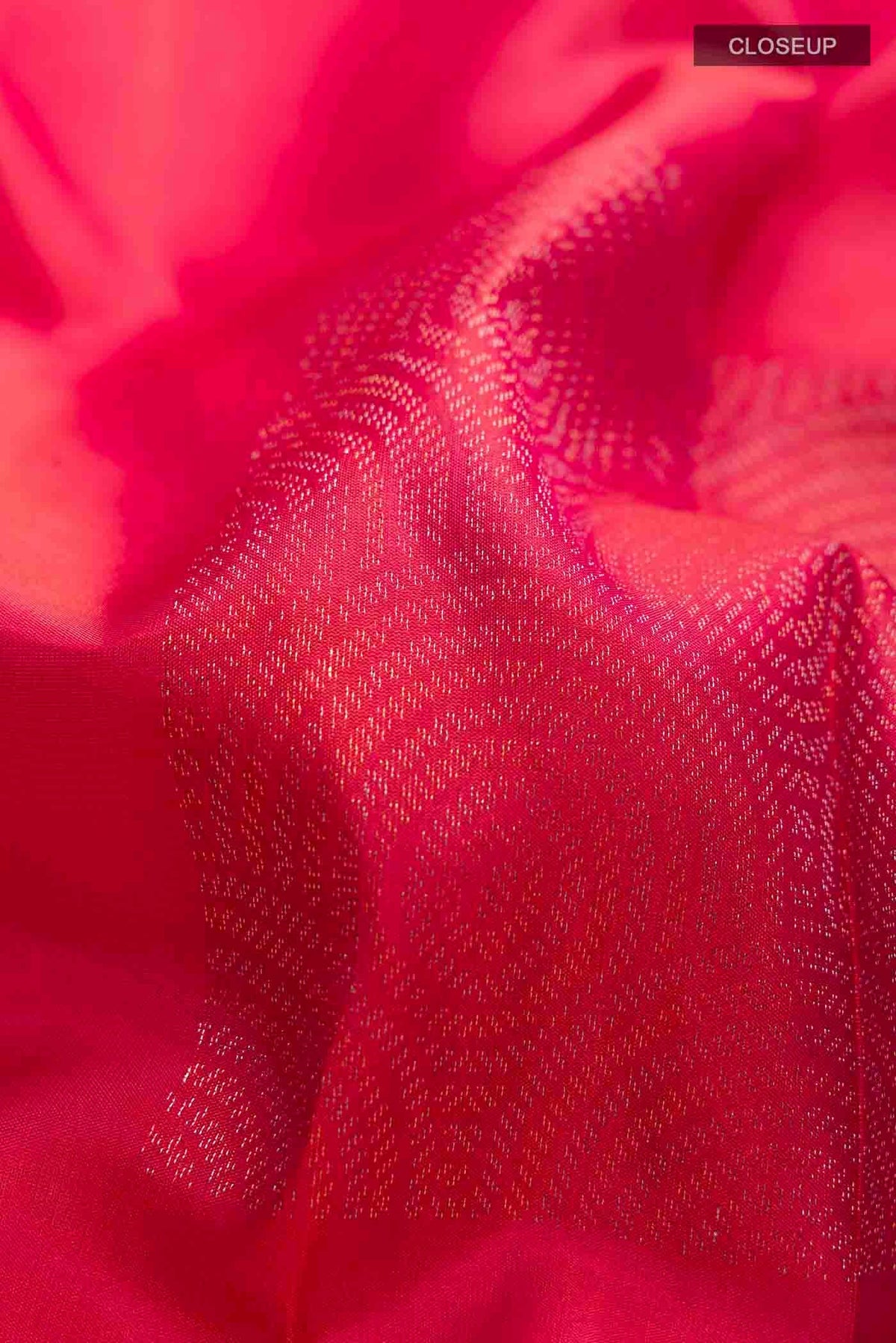 Close up of Pink Soft Silk Saree with Zari Butta on the body and Without Border displaying folds
