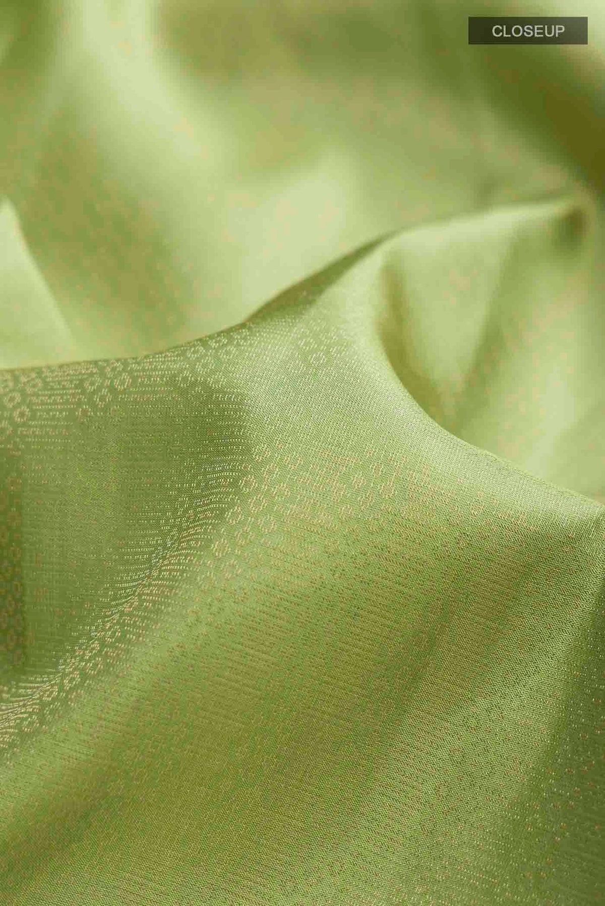 Close up of Green Soft Silk Saree with Zari Brocade on the body and Zari Border displaying folds
