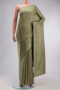 Green Soft Silk Saree with Zari Butta on the body and Zari Border displayed on a mannequin