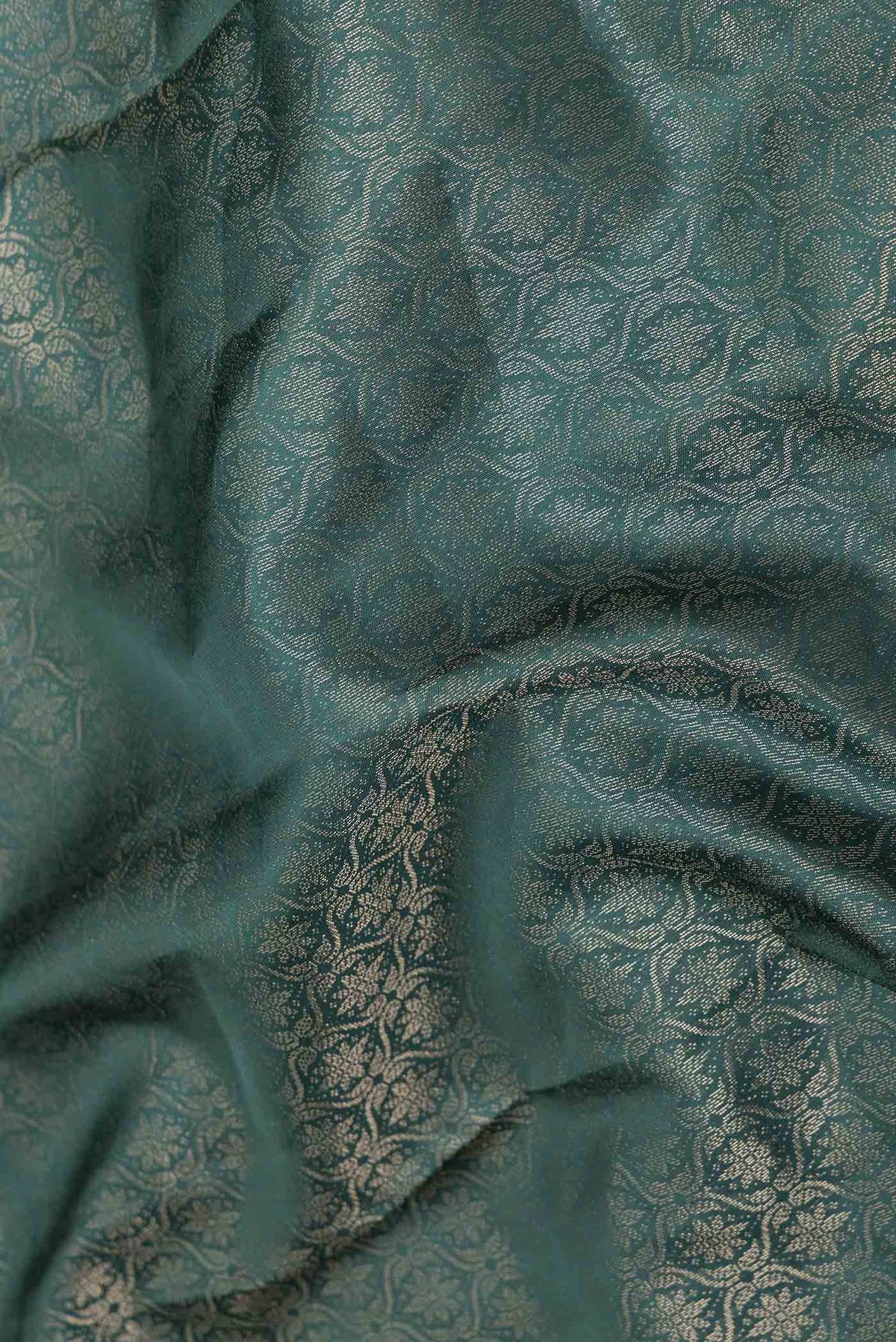 Close up of Bottle Green Dual Tone Soft Silk Saree with Zari Brocade on the body and Zari Border displaying folds