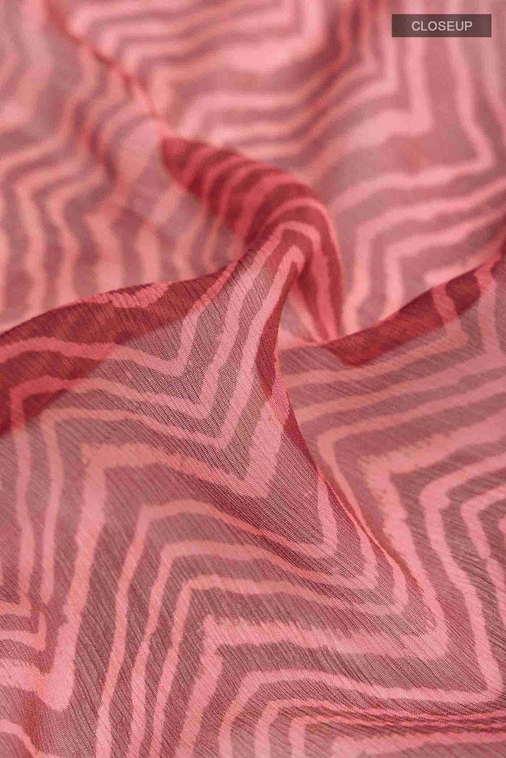 Close up of Bronze Mysore Chiffon Saree with Printed design on the body and Plain Border displaying folds