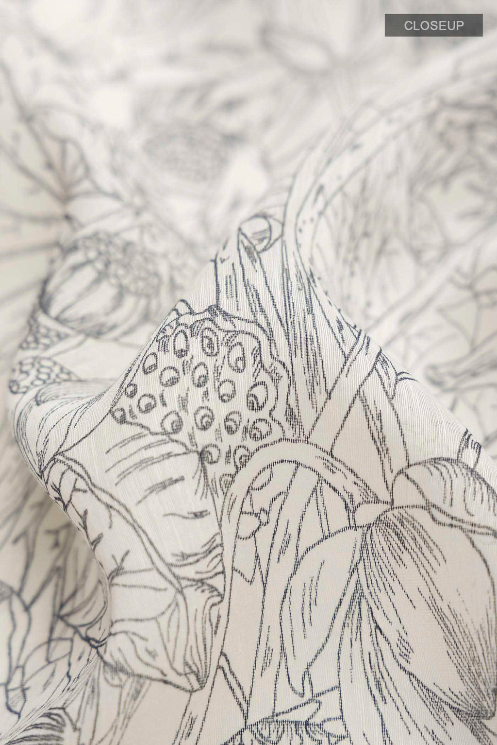 Close up of White Bhagalpuri Tussar Silk Saree with Printed design on the body and Zari Border displaying folds