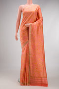 Peach Printed Silk Saree with Printed design on the body and Zari Border.  displayed on a mannequin