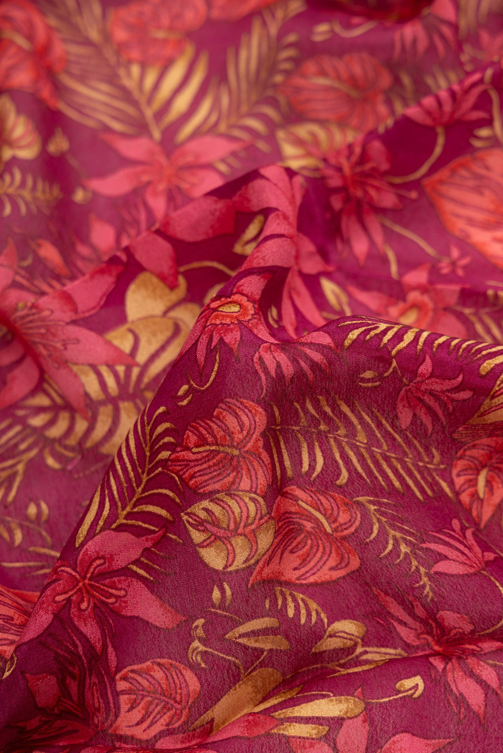 Close up of Magenta Dual Tone Mysore Crepe Saree with Printed design on the body and Thread Border.  displaying folds
