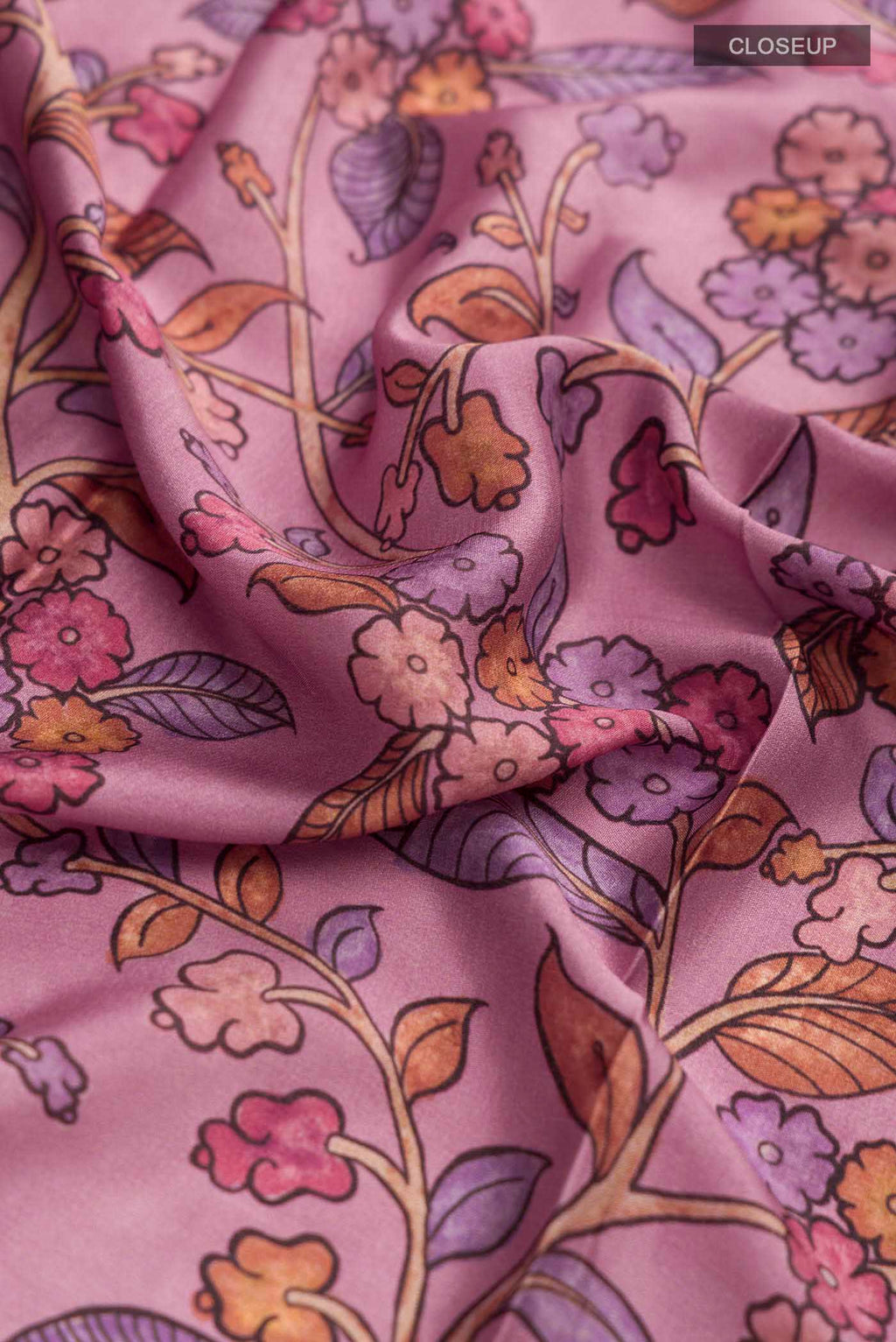 Close up of Mauve Mysore Crepe Saree with Printed design on the body and Zari Border displaying folds