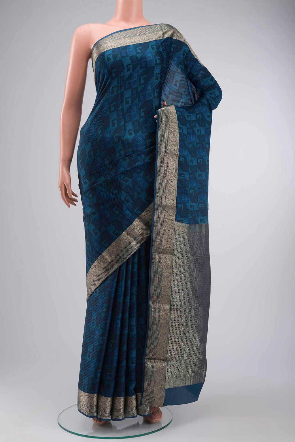 Blue Mysore Crepe Saree with Printed design on the body and Zari Border displayed on a mannequin