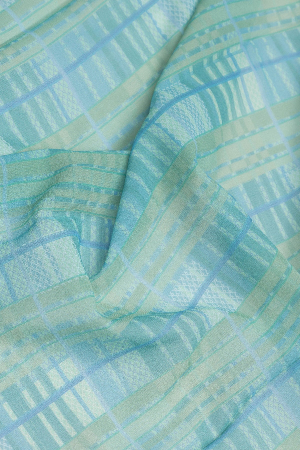 Close up of Mehandi Green Dual Tone Mysore Georgette Saree with Printed design on the body and Printed Border.  displaying folds