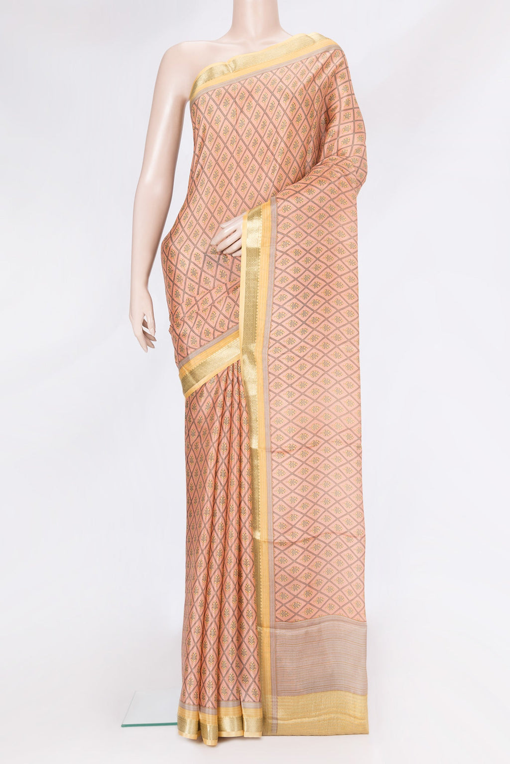 Peach Dual Tone Crepe Saree with Printed design on the body and Zari Border.  displayed on a mannequin