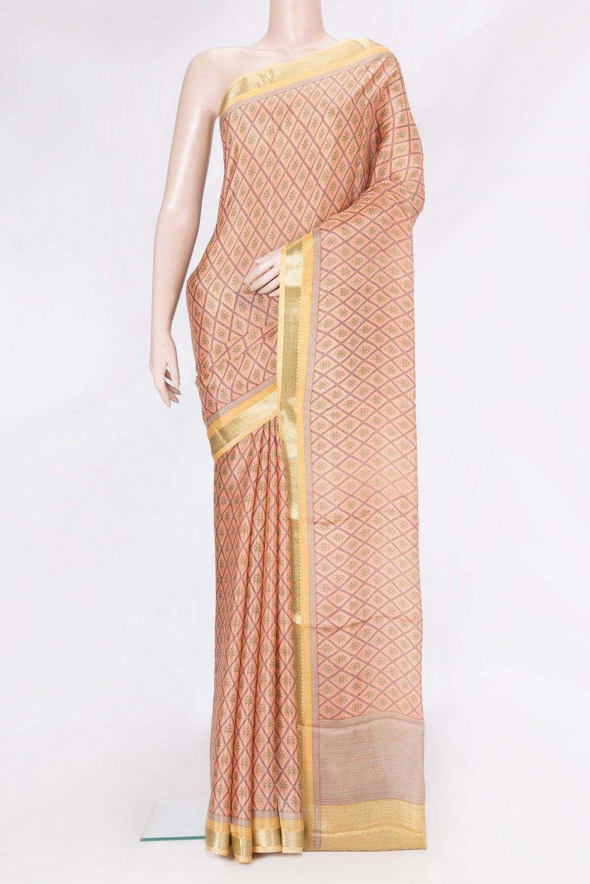 Peach Dual Tone Crepe Saree with Printed design on the body and Zari Border.  displayed on a mannequin