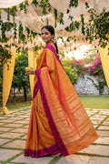 Model wearing a Mustard Kanchipuram Silk Saree with Zari Butta on the body and Plain Border.