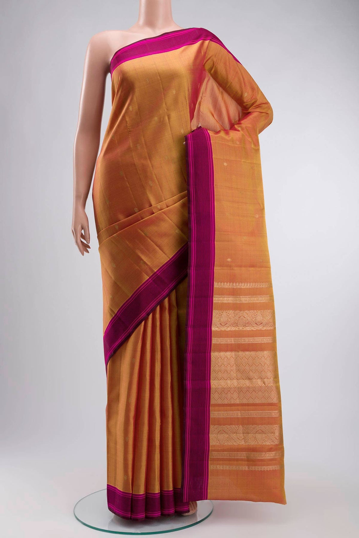 Mustard Kanchipuram Silk Saree with Zari Butta on the body and Plain Border displayed on a mannequin