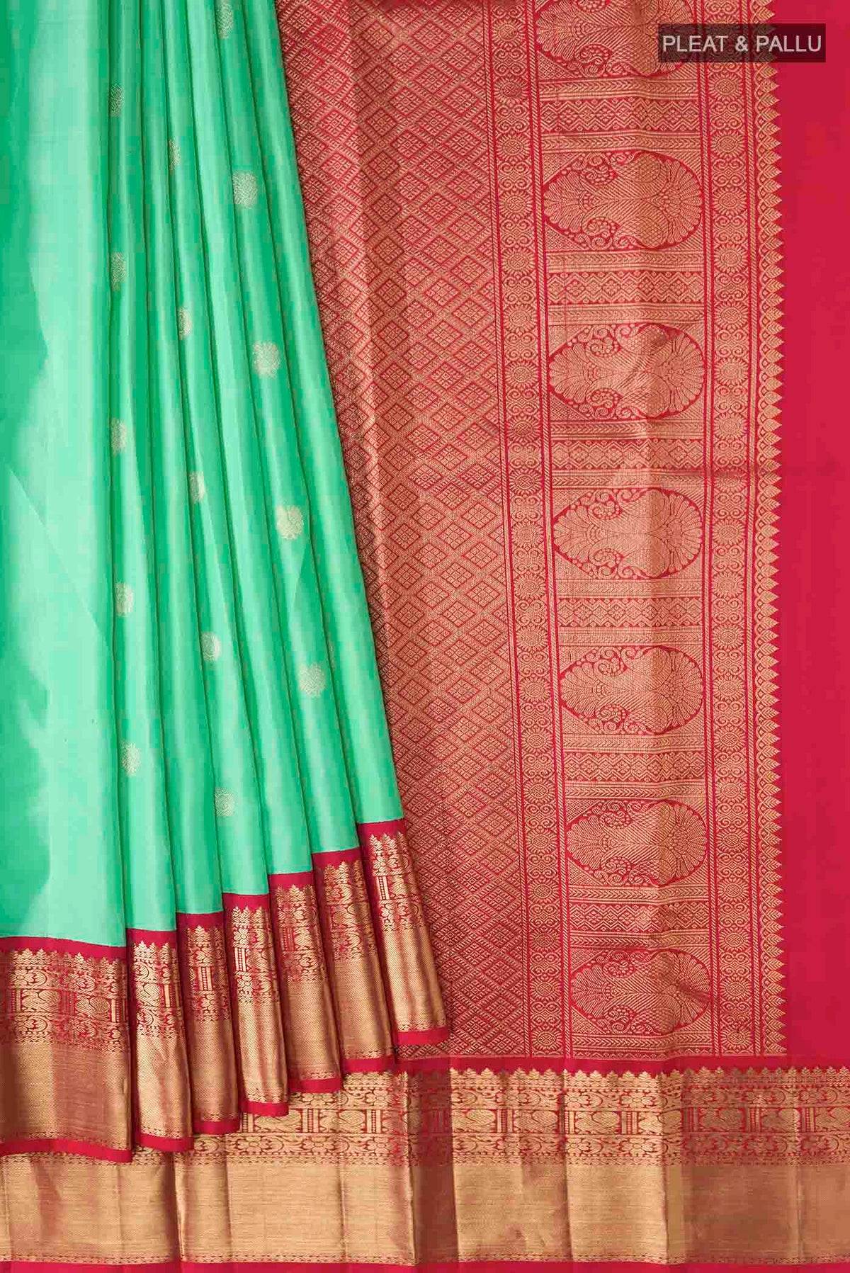 Pleats and pallu of Green Kanchipuram Silk Saree with Zari Butta on the body and Zari Border