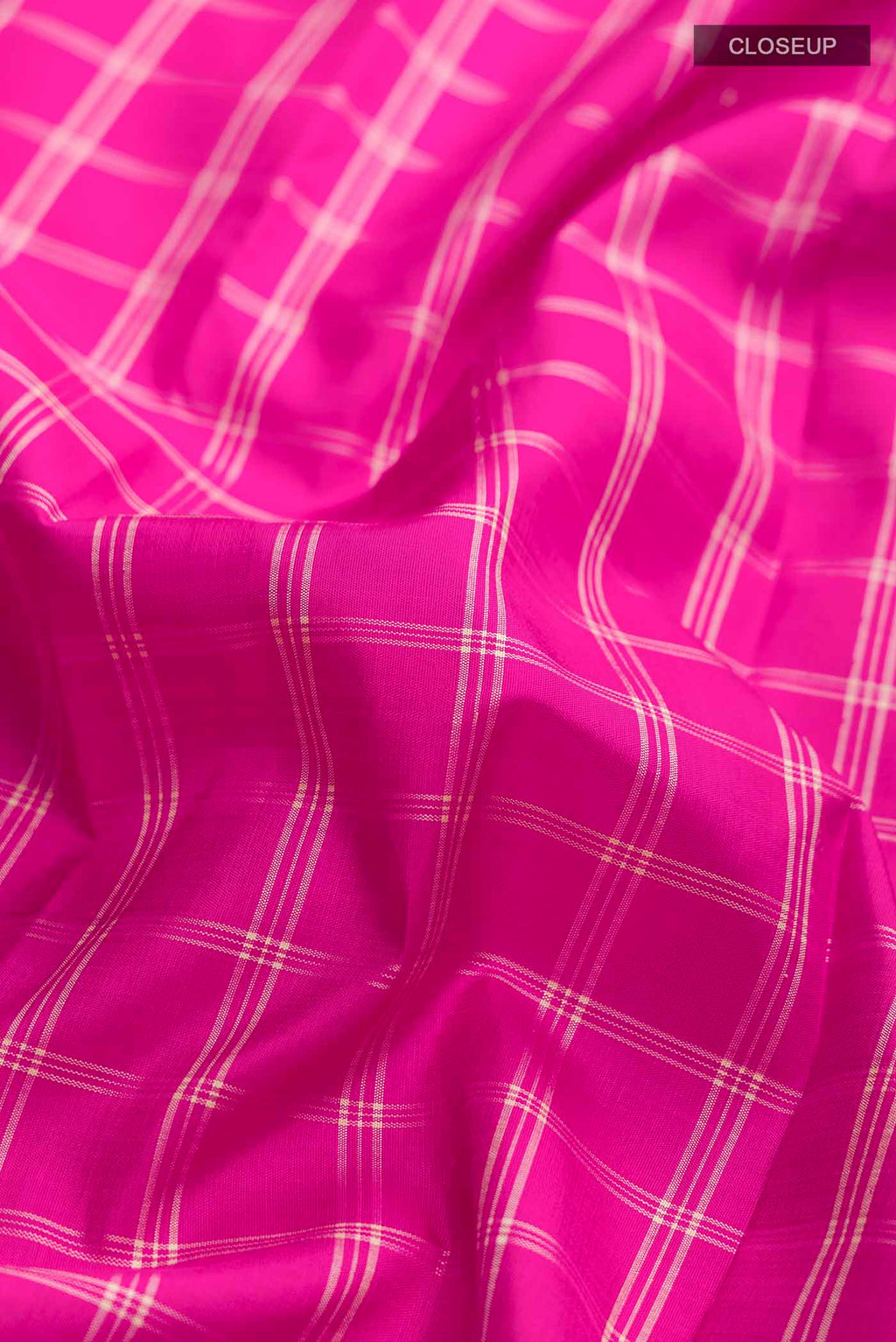Close up of Pink Kanchipuram Silk Saree with Checked design on the body and Plain Border displaying folds