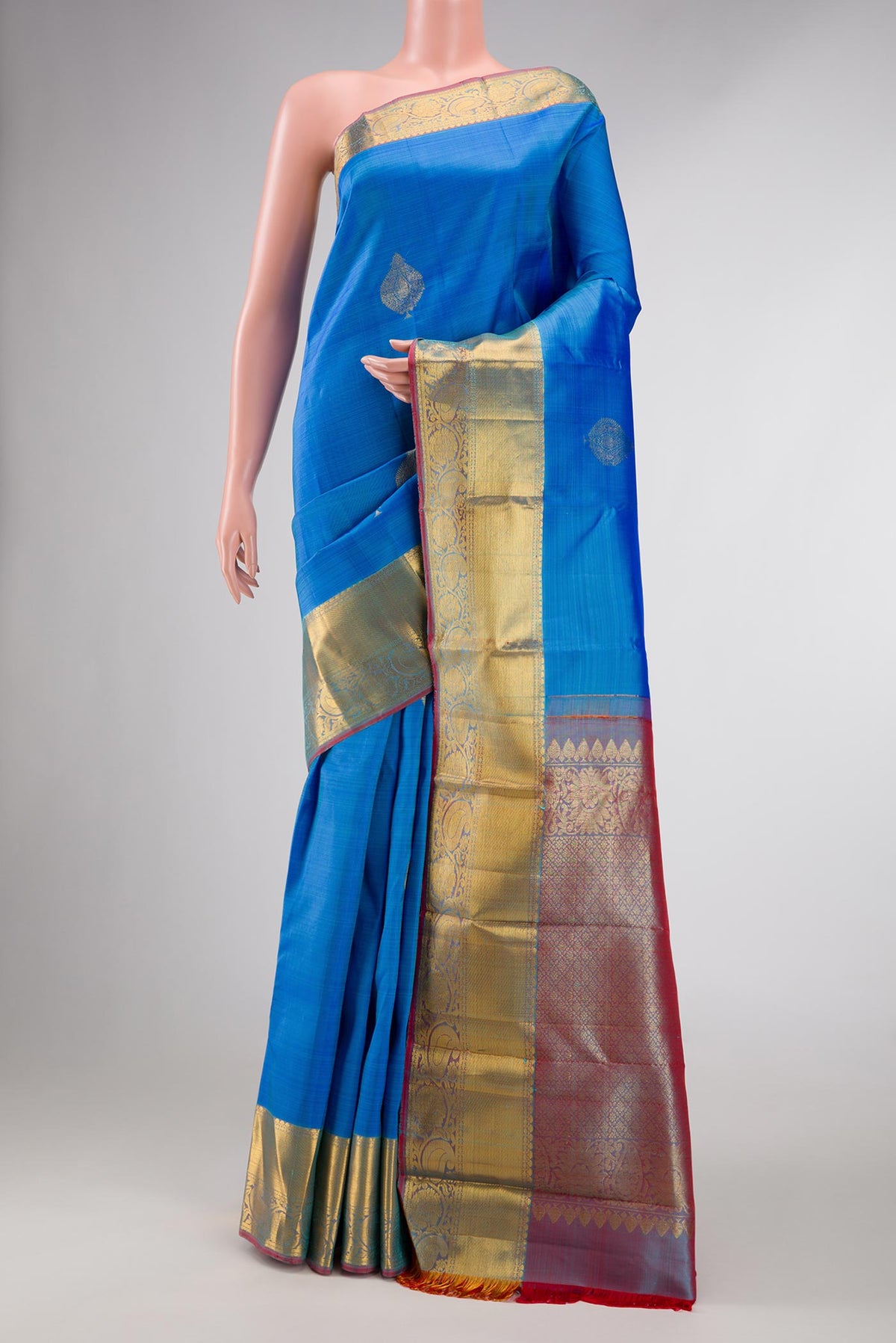 Blue Dual Tone Kanchipuram Silk Saree with Zari Butta on the body and Zari Border displayed on a mannequin