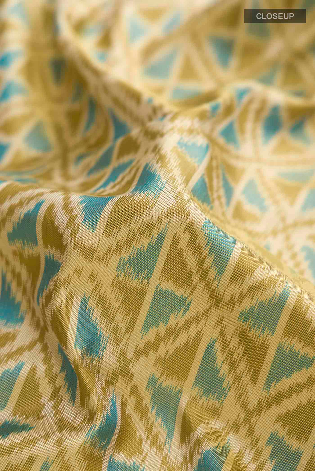 Close up of Green Pochampally Silk Saree with Pure Ikat on the body and Zari Border displaying folds