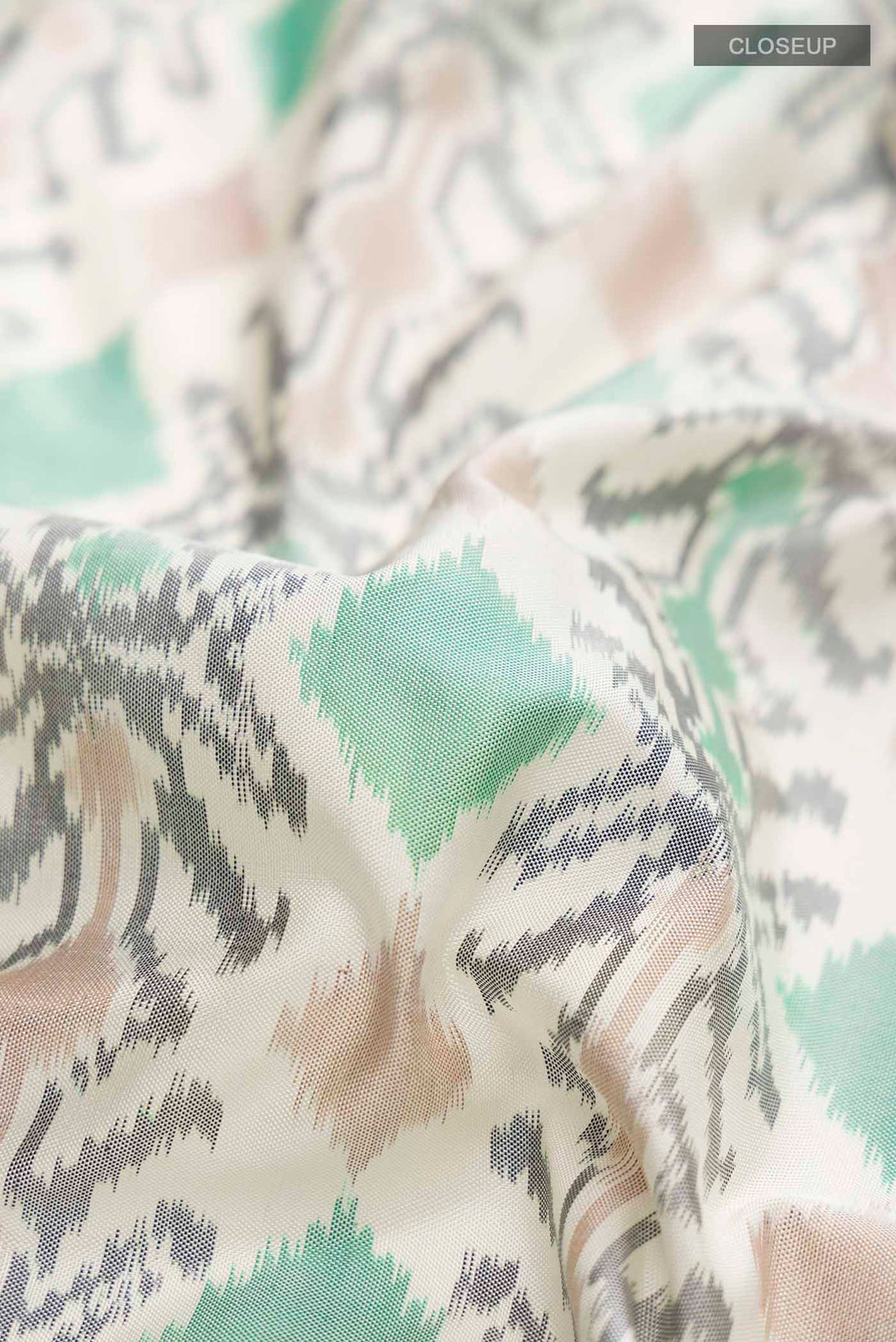 Close up of White Pochampally Silk Saree with Pure Ikat on the body and Zari Border displaying folds