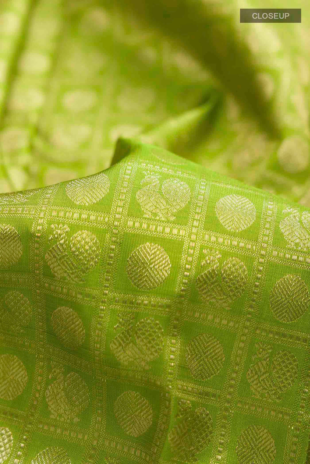 Close up of Green Kanchipuram Silk Saree with Zari Brocade on the body and Zari Border displaying folds