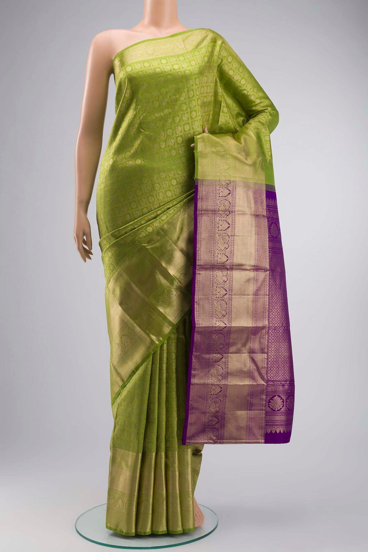 Green Kanchipuram Silk Saree with Zari Brocade on the body and Zari Border displayed on a mannequin