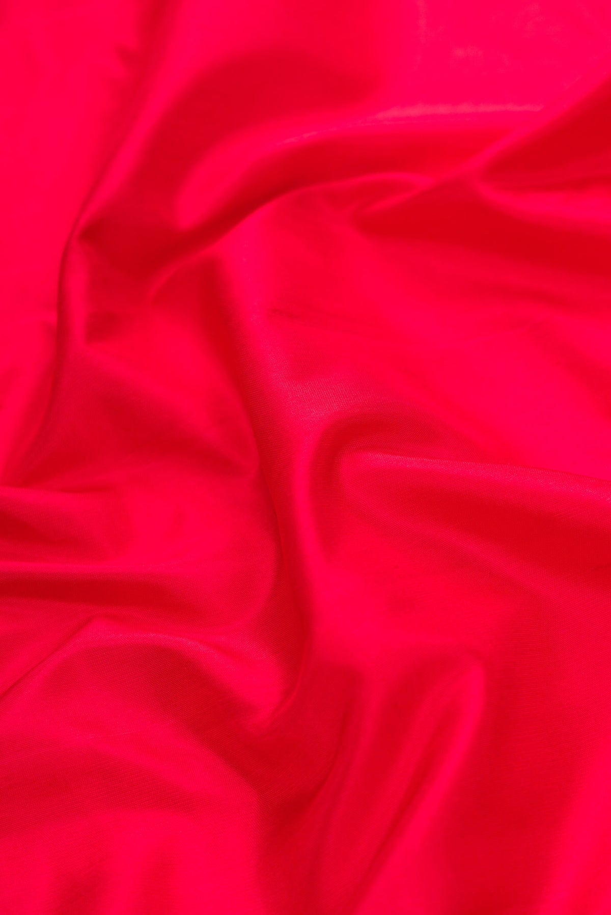 Close up of Red Dual Tone Gadwal Silk Saree with Plain Body and Temple Border.  displaying folds