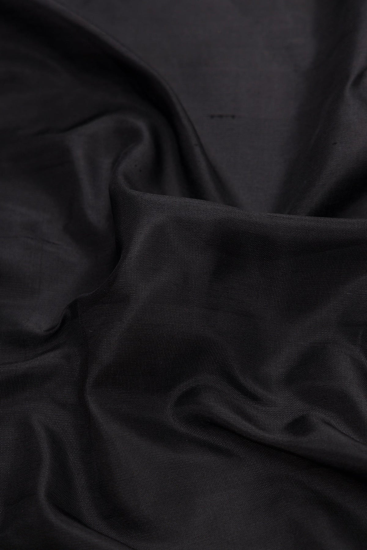 Close up of Black Dual Tone Gadwal Silk Saree with Plain Body and Thread Border.  displaying folds