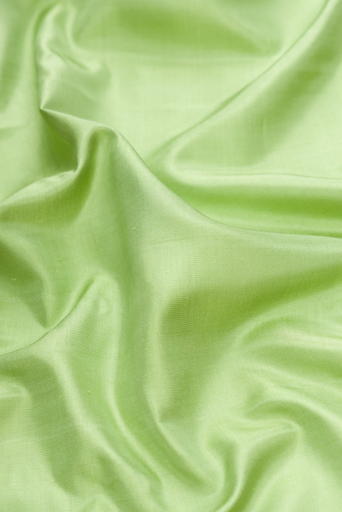 Close up of Pista Green Dual Tone Gadwal Silk Saree with Plain Body and Temple Border.  displaying folds