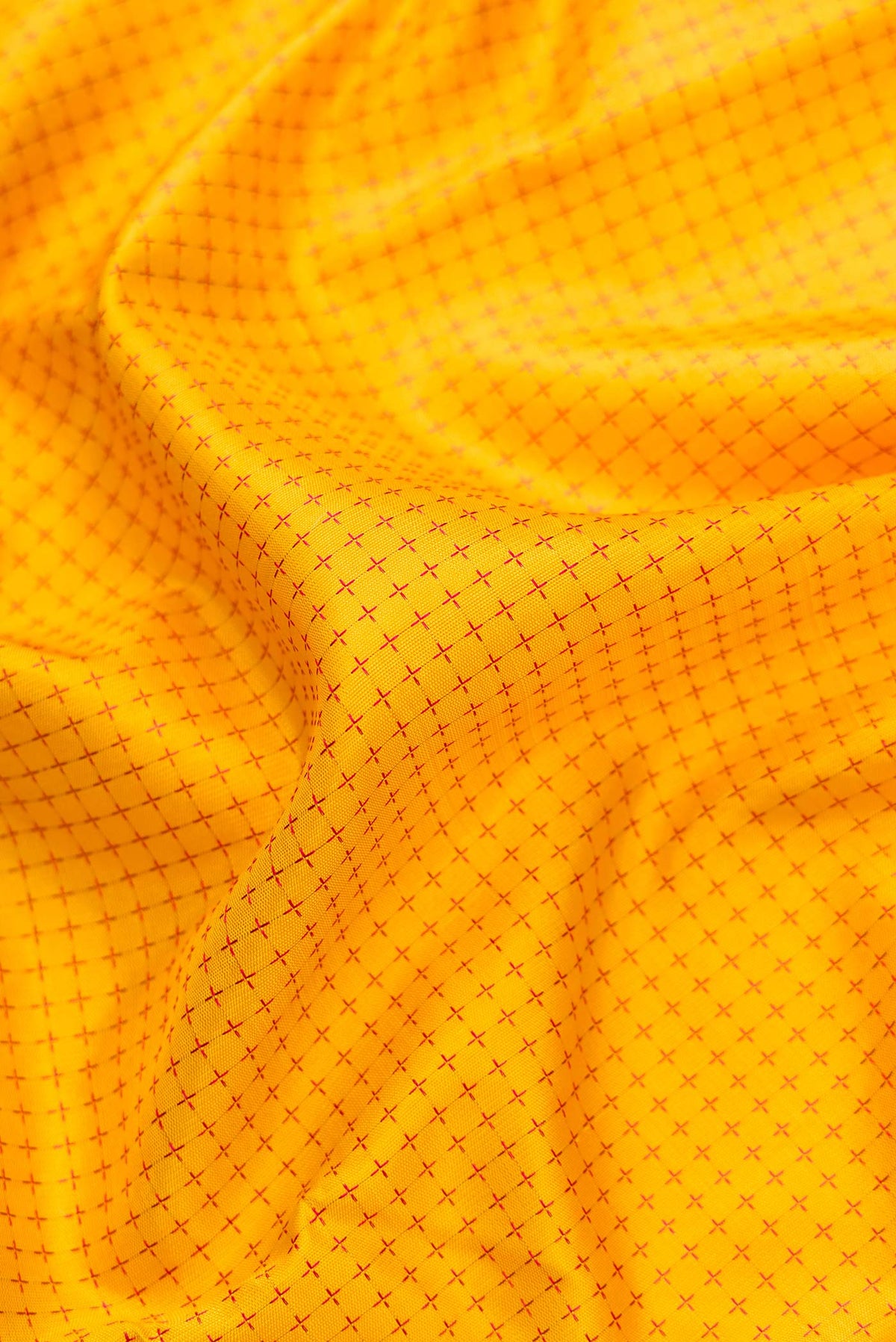 Close up of Pure Silk Pure Zari Yellow Dual Tone Kanjivaram Saree with Thread Butta on the body and Zari Border.  displaying folds