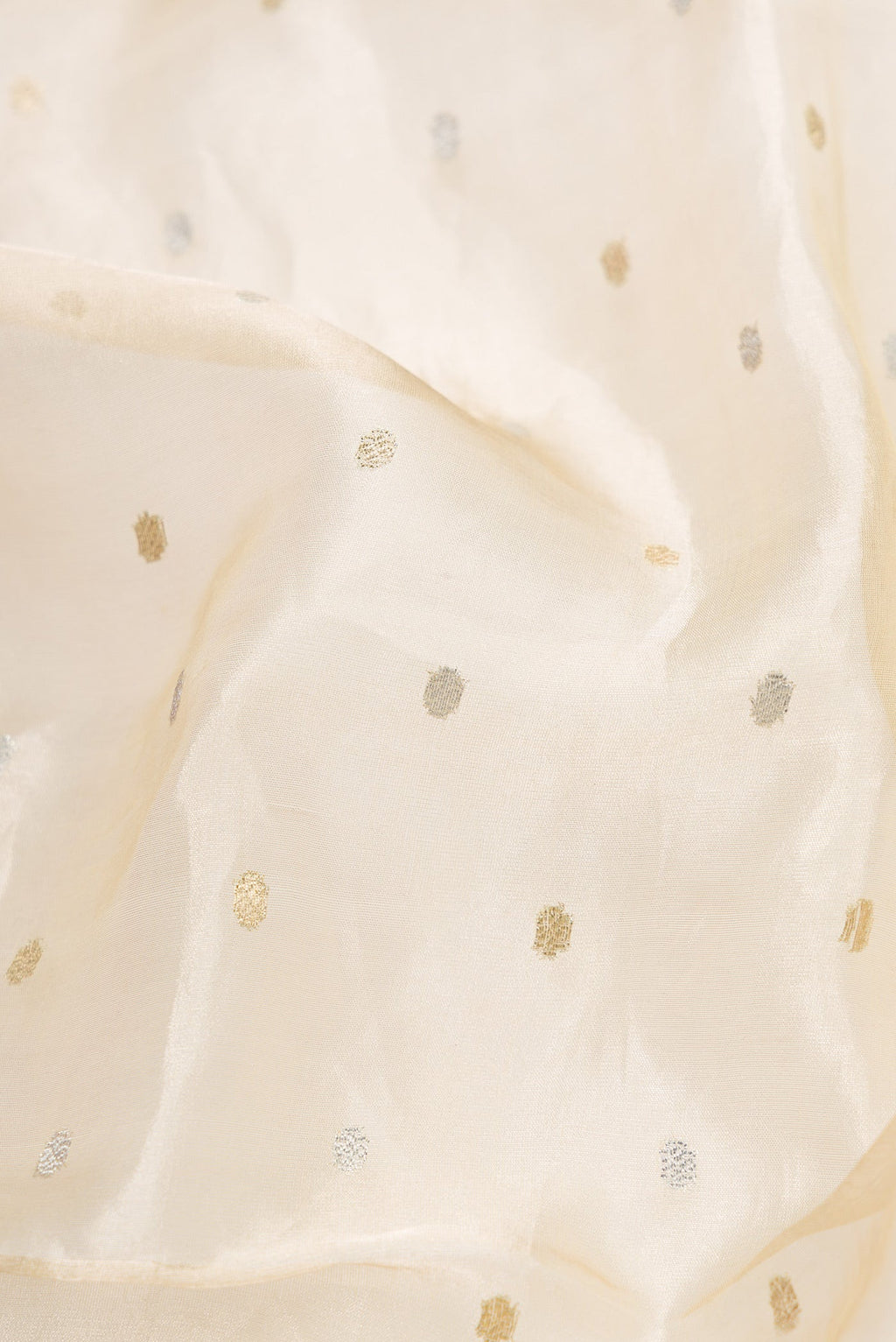 Close up of Sandal Dual Tone Organza Silk Saree with Zari Butta on the body and Fancy Border.  displaying folds