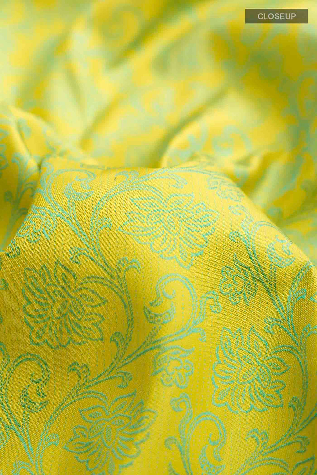 Close up of Green Kanchipuram Silk Saree with Jacquard design on the body and Zari Border displaying folds