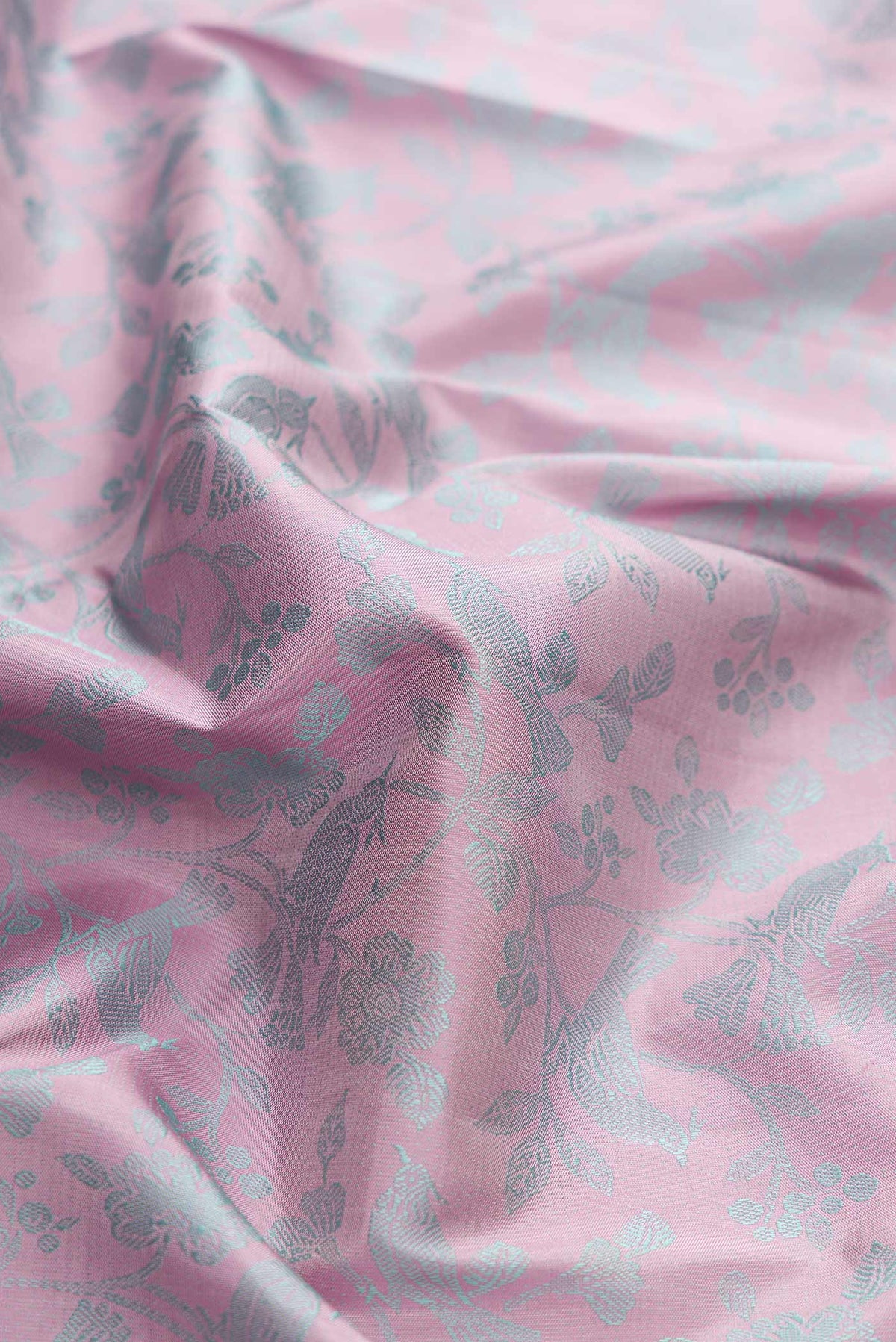 Close up of Pure Silk Pure Zari Pink Dual Tone Kanchipuram Saree with Jacquard design on the body and Fancy Border displaying folds