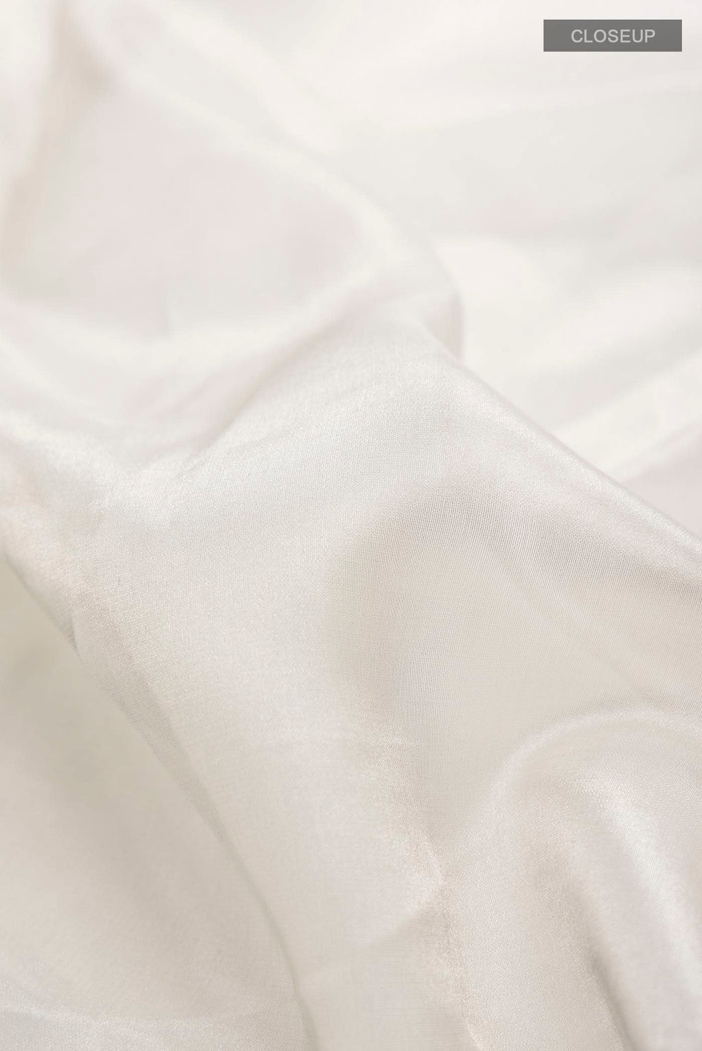 Close up of Multi Color Tissue Silk Saree with Plain Body and Plain Border displaying folds