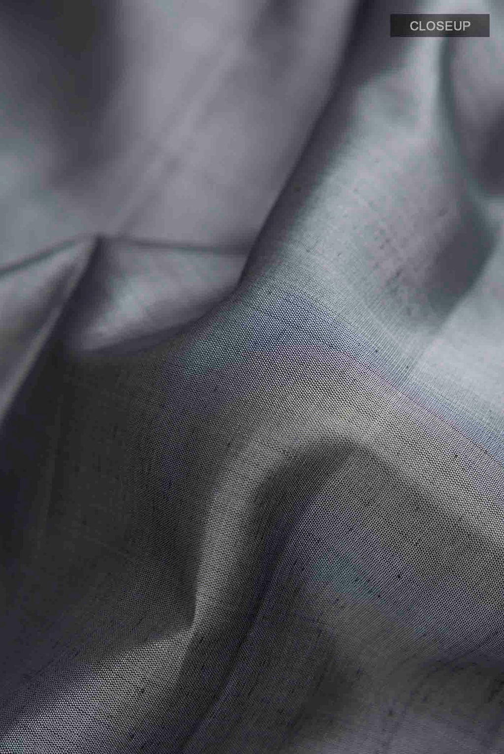 Close up of Grey Kanchipuram Silk Saree with Plain Body and Zari Border displaying folds