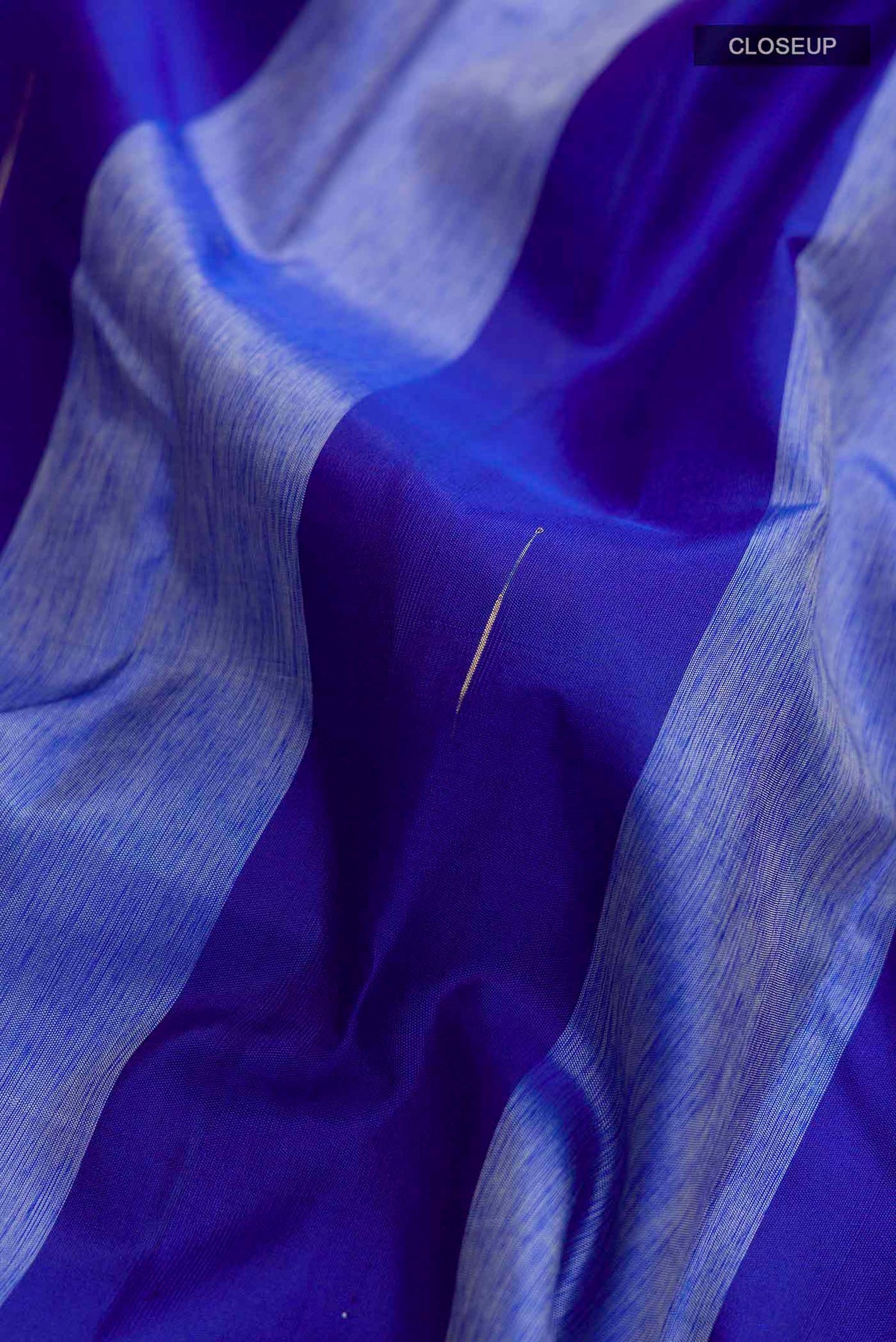 Close up of Blue Kanchipuram Silk Saree with Stripes on the body and Zari Border displaying folds