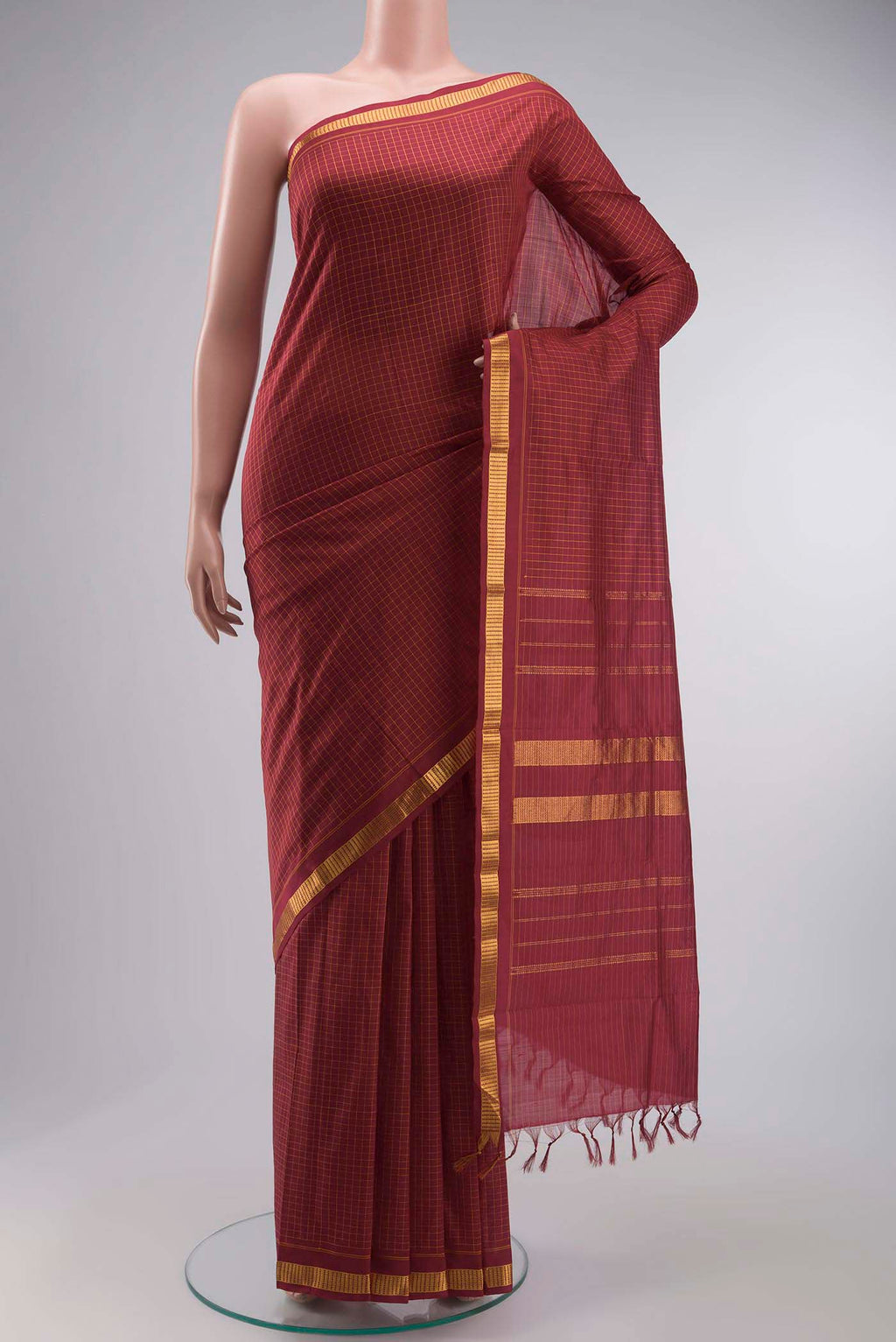 Maroon Kanchipuram Silk Saree with Checked design on the body and Zari Border displayed on a mannequin