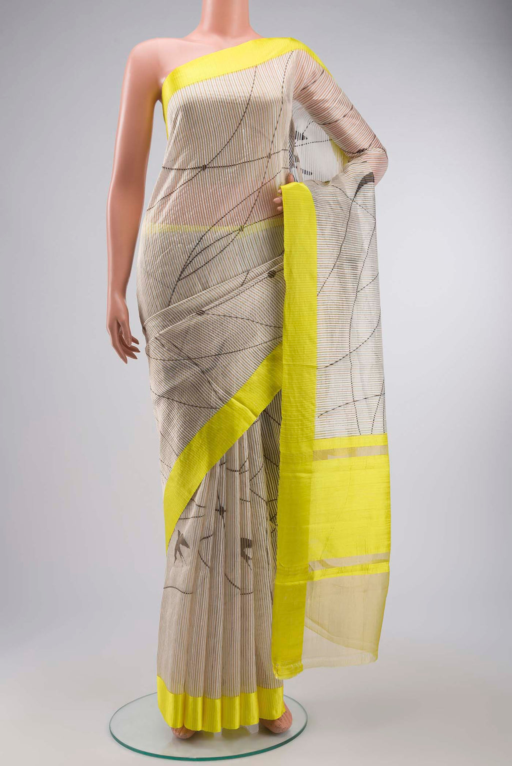 Off White Kora Silk Saree with Stripes on the body and Zari Border displayed on a mannequin