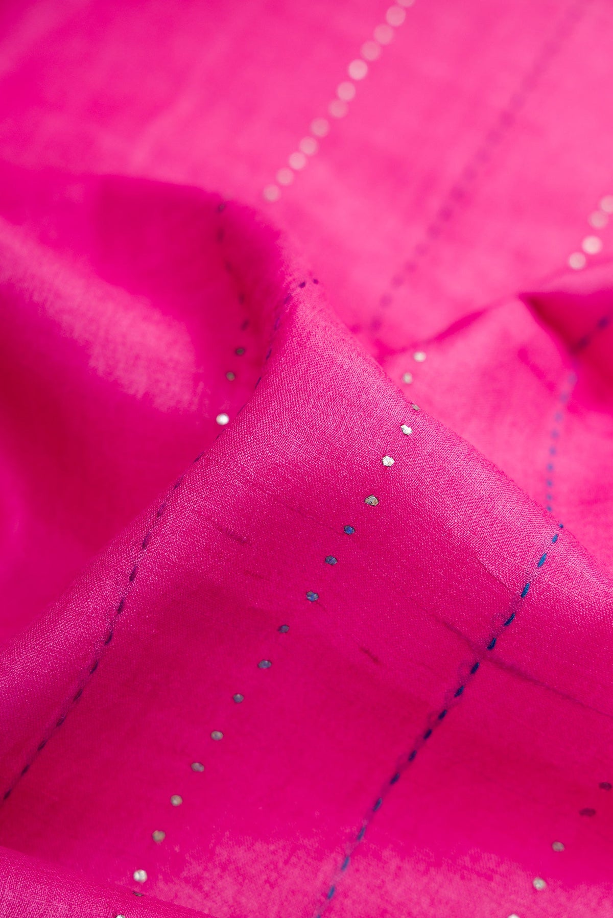 Close up of Pink Dual Tone Tussar Silk Saree with Embroidery on the body and Embroidery Border.  displaying folds