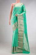Light Green Dual Tone Kanchipuram Silk Saree with Zari Butta on the body and Zari Border displayed on a mannequin