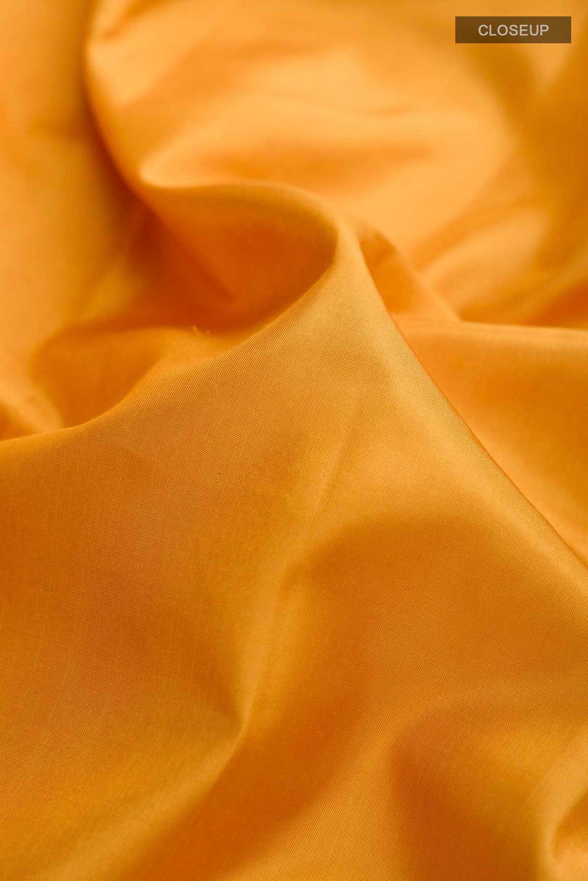 Close up of Yellow Kanchipuram Silk Saree with Plain Body and Zari Border displaying folds