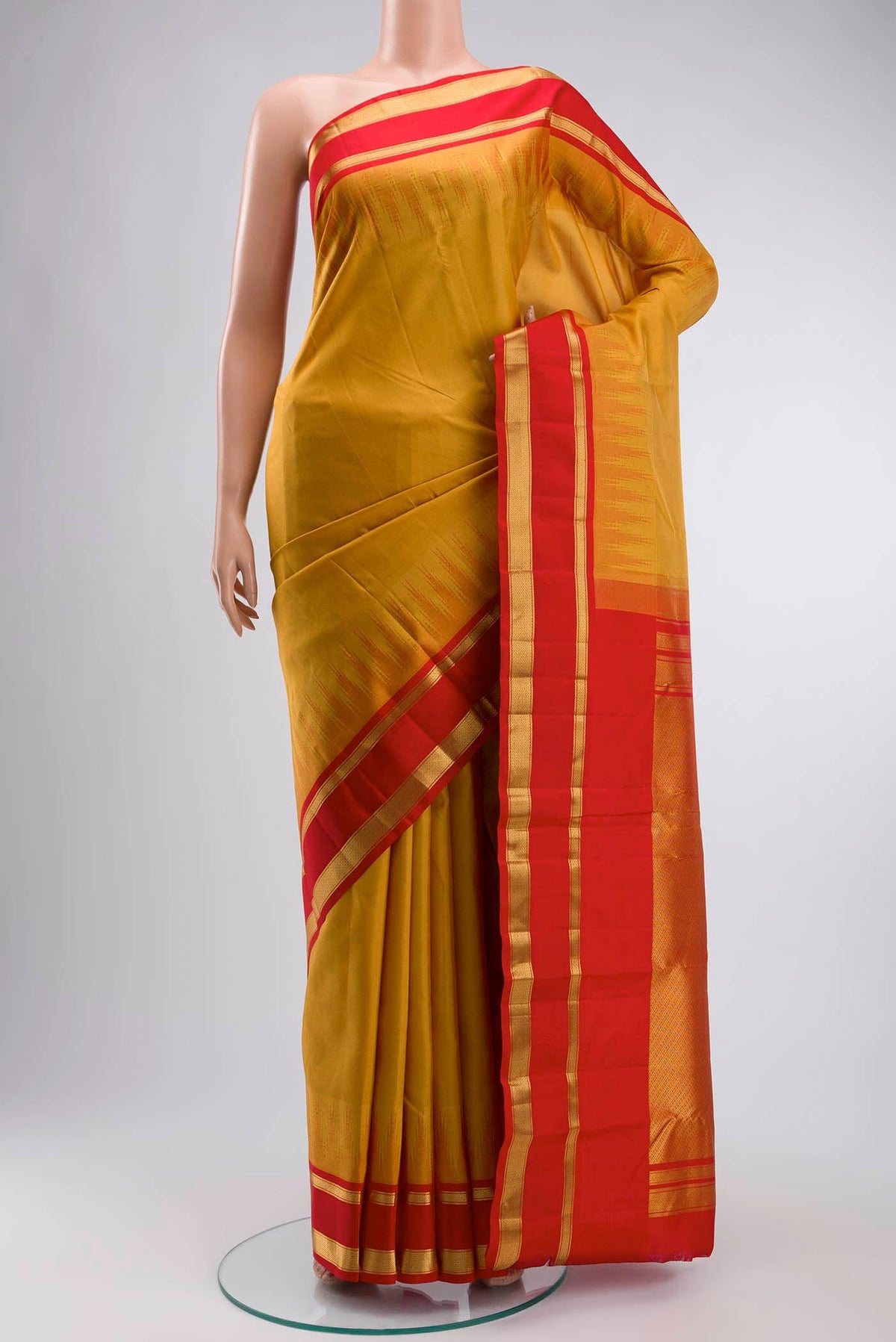 Yellow Kanchipuram Silk Saree with Plain Body and Zari Border displayed on a mannequin