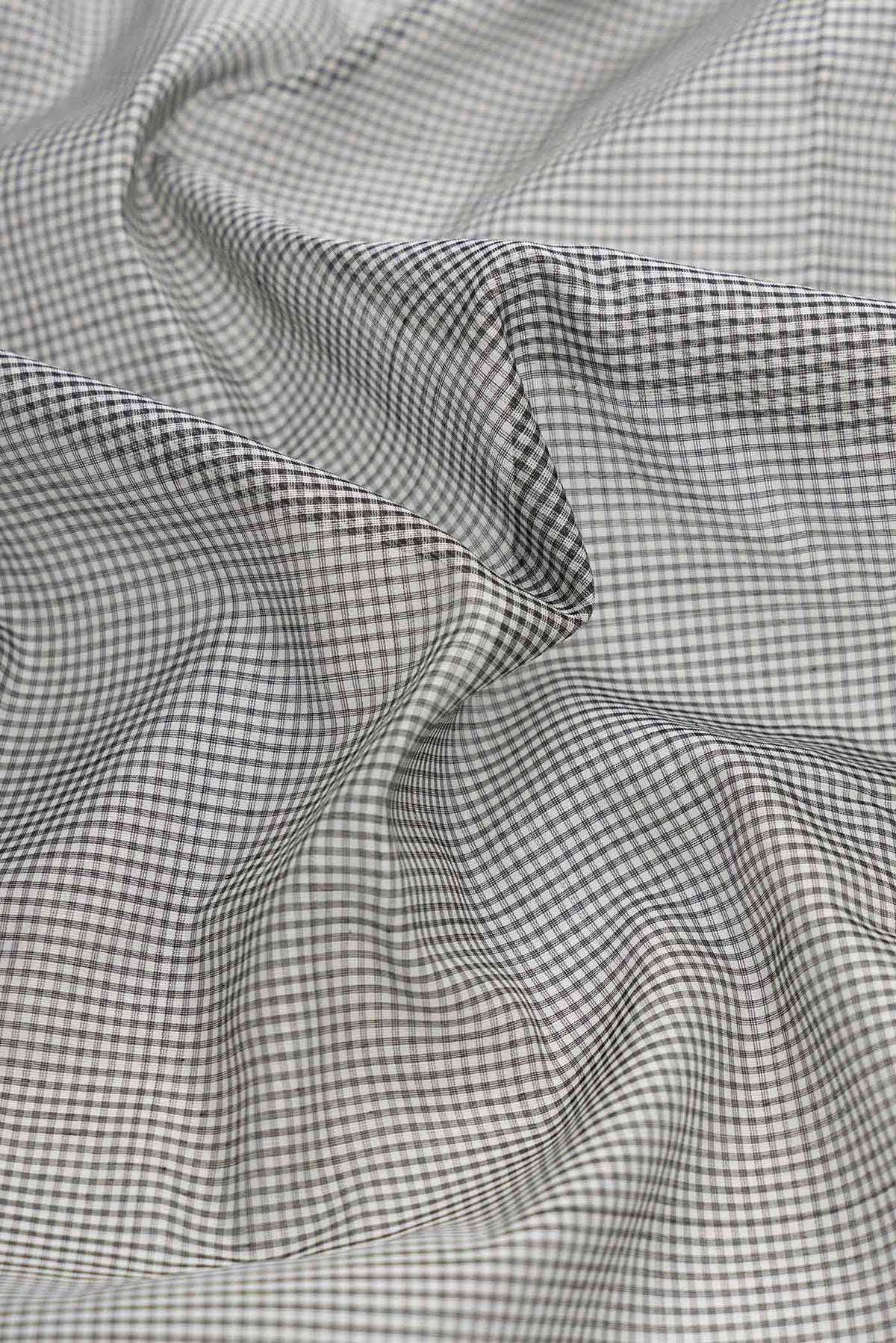 Close up of Grey Dual Tone Silk Cotton Saree with Checked design on the body and Zari Border displaying folds