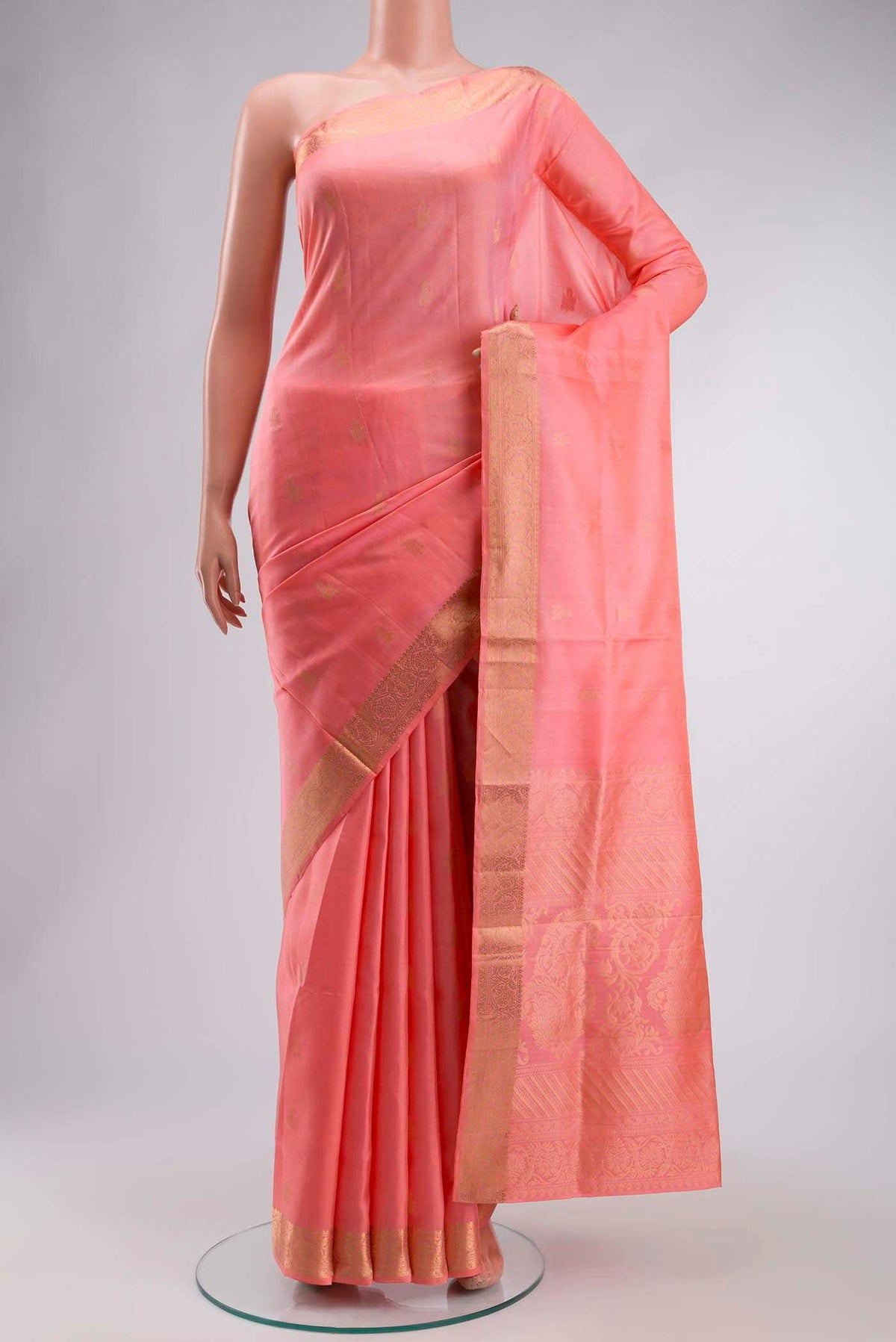Coral Soft Silk Saree with Zari Butta on the body and Zari Border displayed on a mannequin