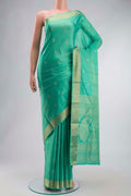 Green Soft Silk Saree with Zari Butta on the body and Zari Border displayed on a mannequin