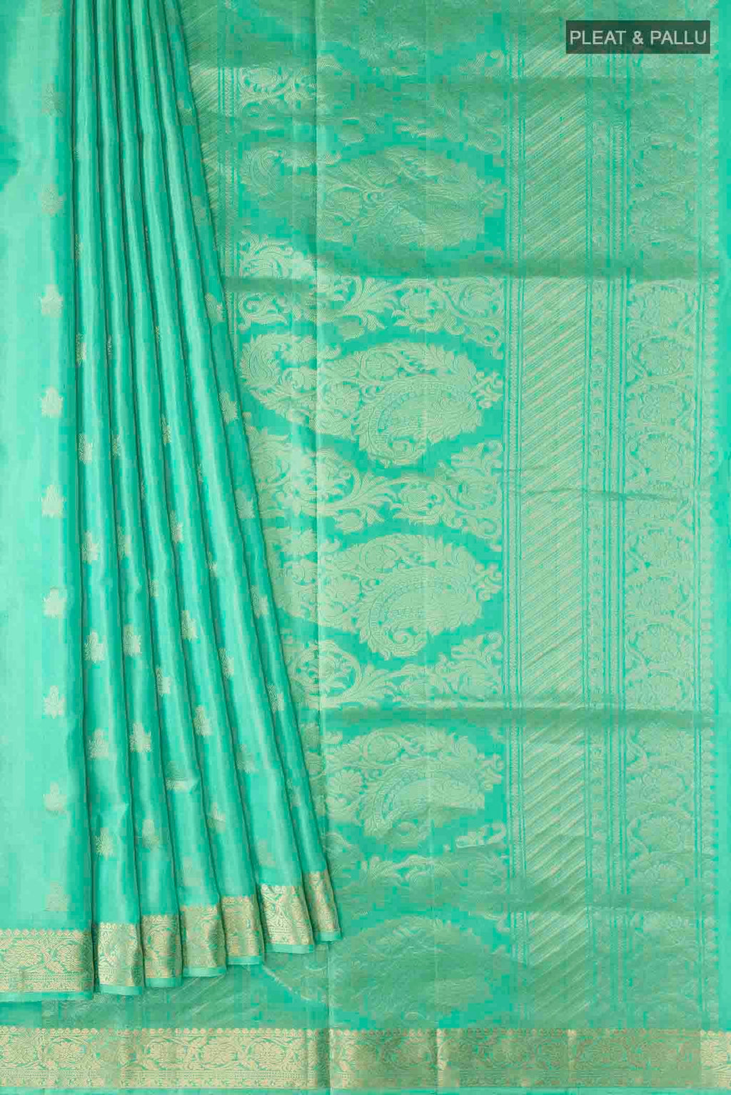 Pleats and pallu of Green Soft Silk Saree with Zari Butta on the body and Zari Border