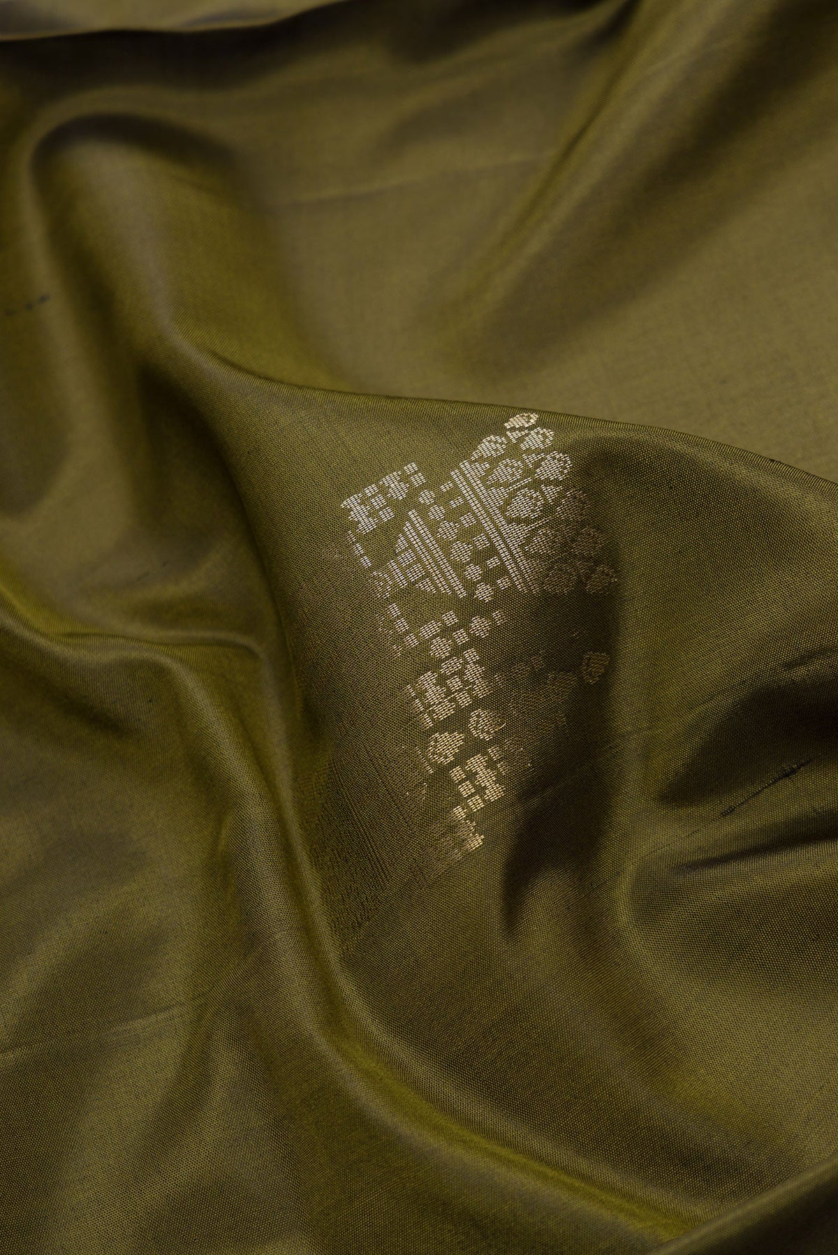 Close up of Mehandi Green Dual Tone Soft Silk Saree with Zari Butta on the body and Zari Border.  displaying folds