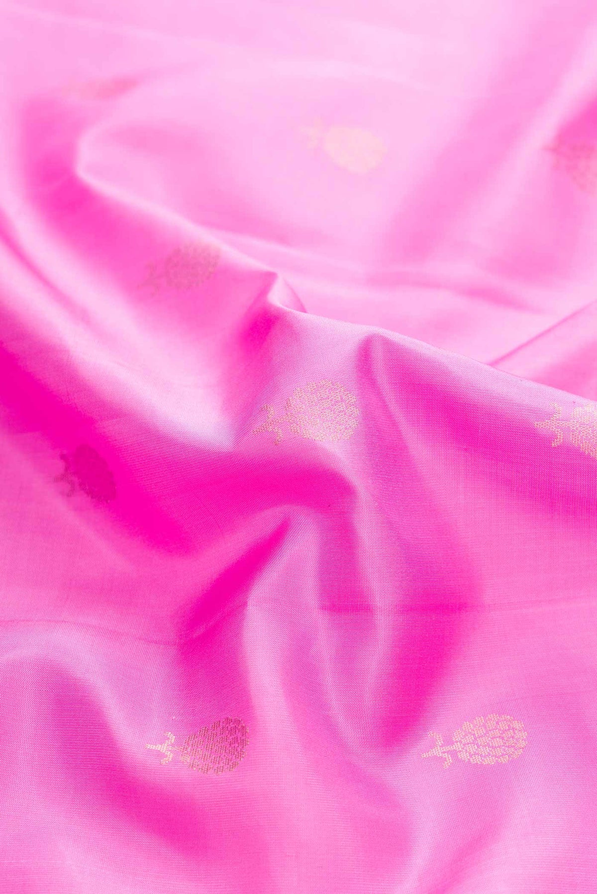 Close up of Rose pink Soft Silk Saree with Zari Butta on the body and Zari Border displaying folds
