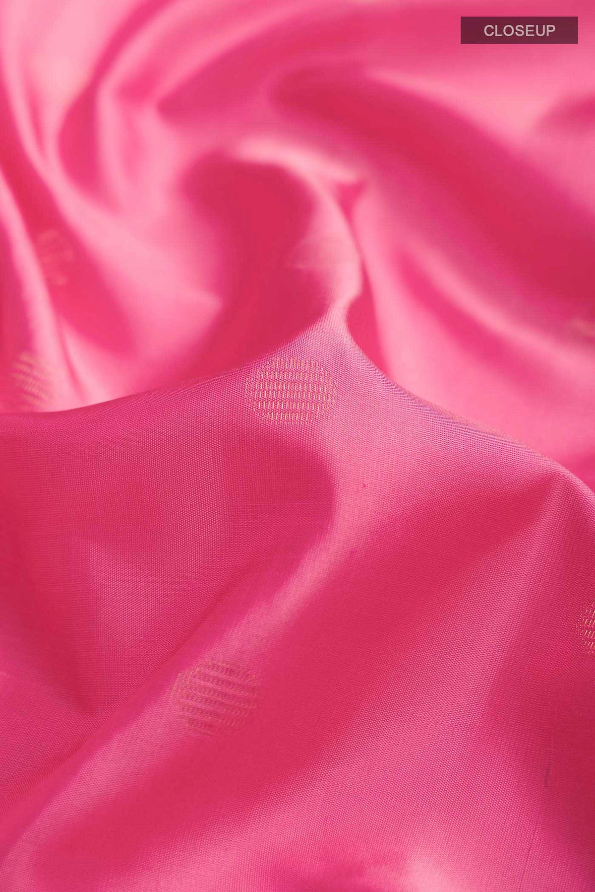 Close up of Pink Soft Silk Saree with Zari Butta on the body and Zari Border displaying folds